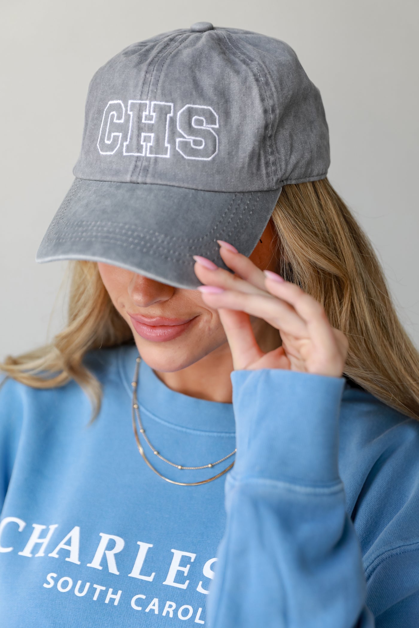 grey CHS Embroidered Hat on model