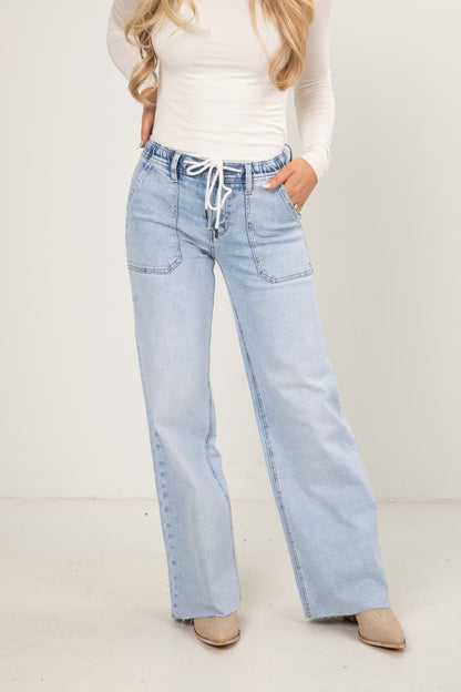 Light blue jeans worn by a person on a white background