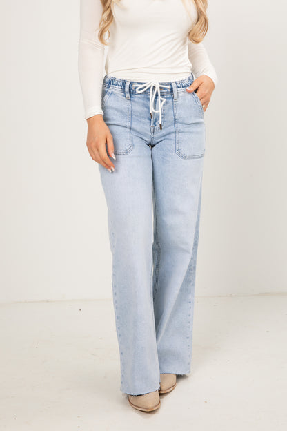 Light blue jeans worn by a person on a white background