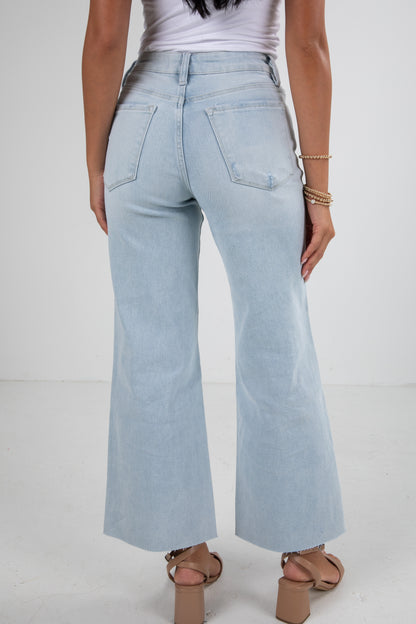 Light blue jeans worn by a person on a white background