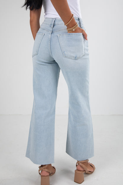 Light blue jeans worn by a person on a white background