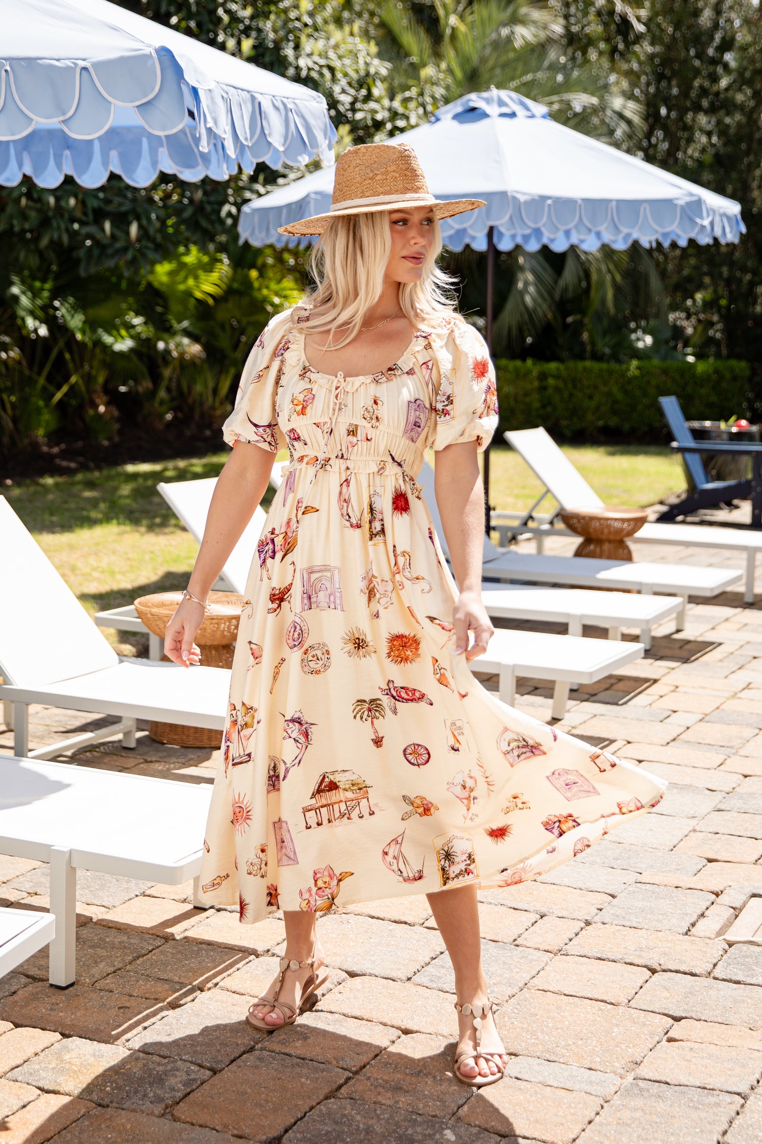 Woman in a floral dress standing outdoors under umbrellas