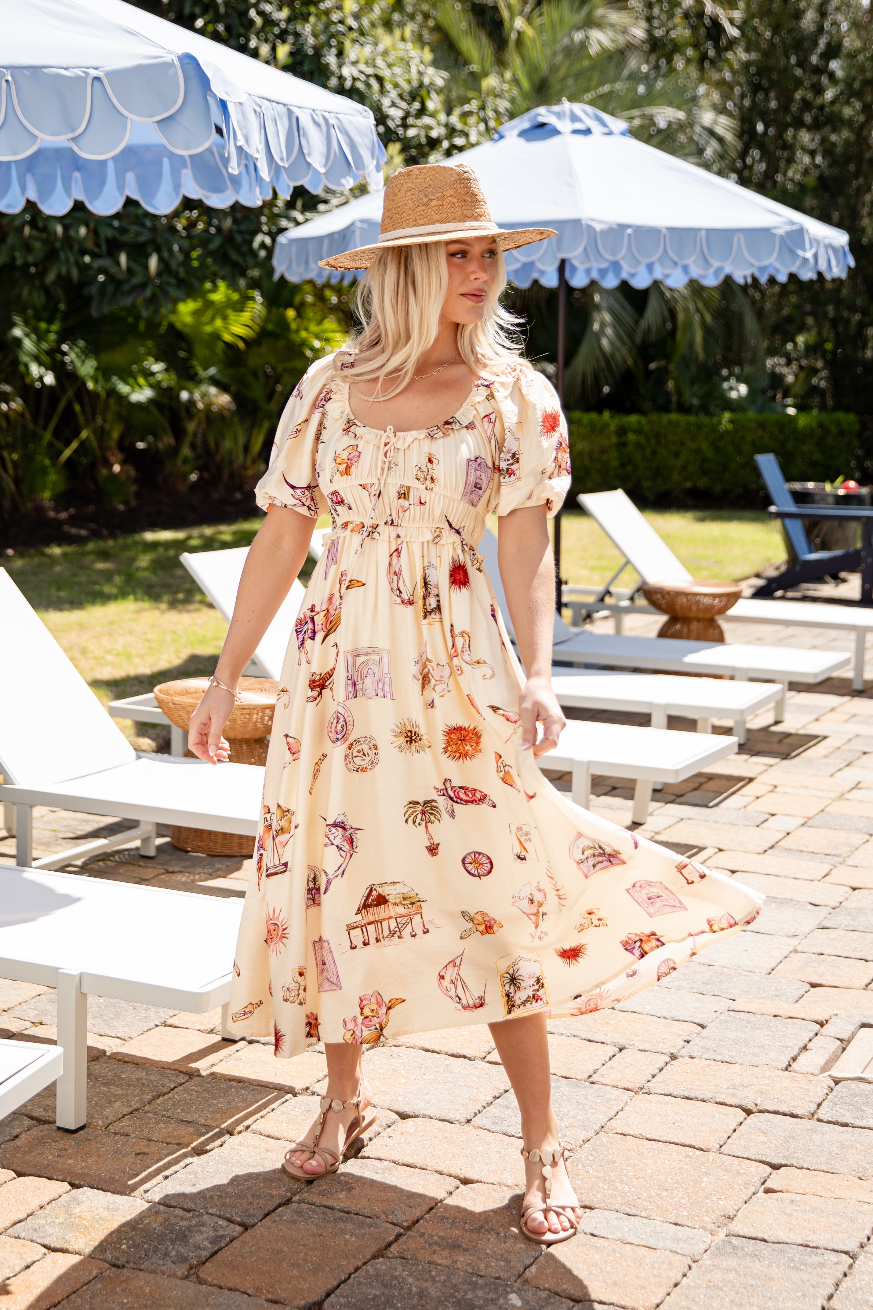Woman in a floral dress standing outdoors under umbrellas