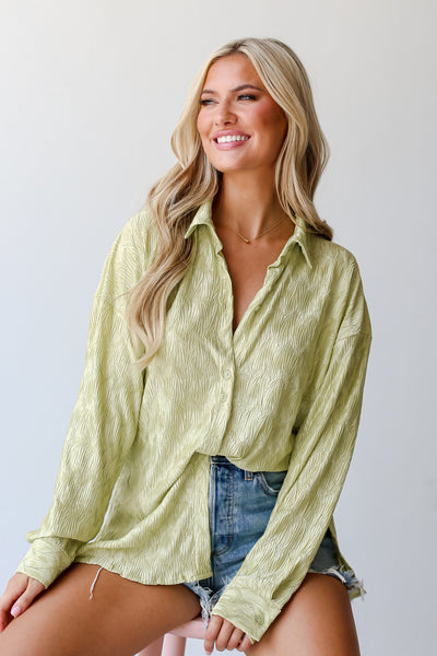 lime green Textured Button-Up Blouse tucked in
