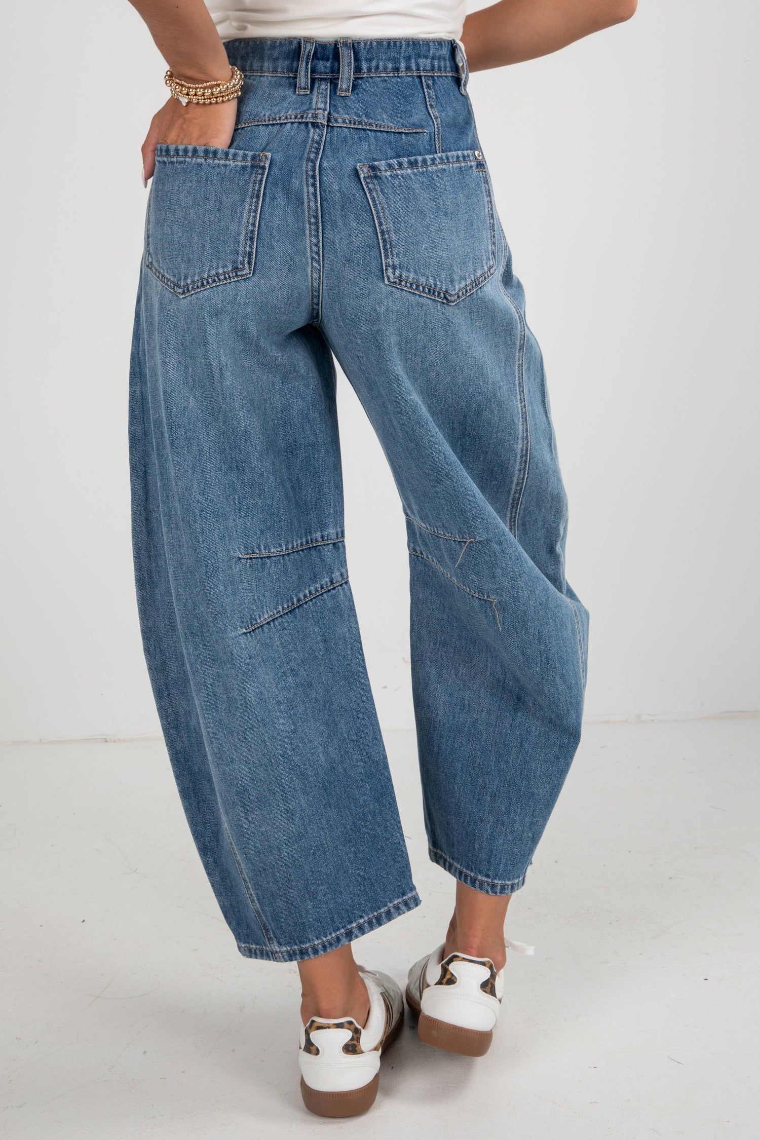 Person wearing blue jeans on a white background