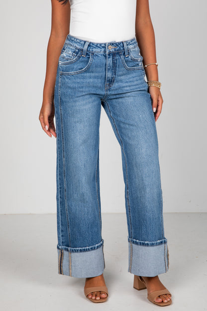 Person wearing blue jeans with a white background