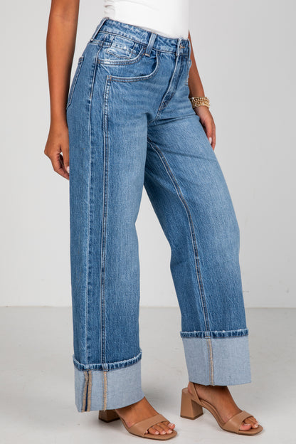 Person wearing blue jeans with a white background