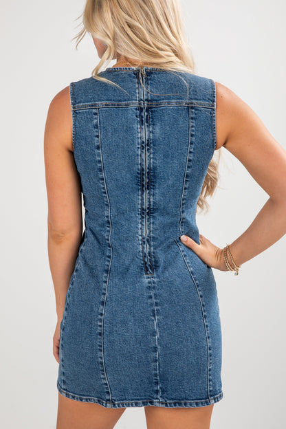 Denim dress worn by a person on a plain background