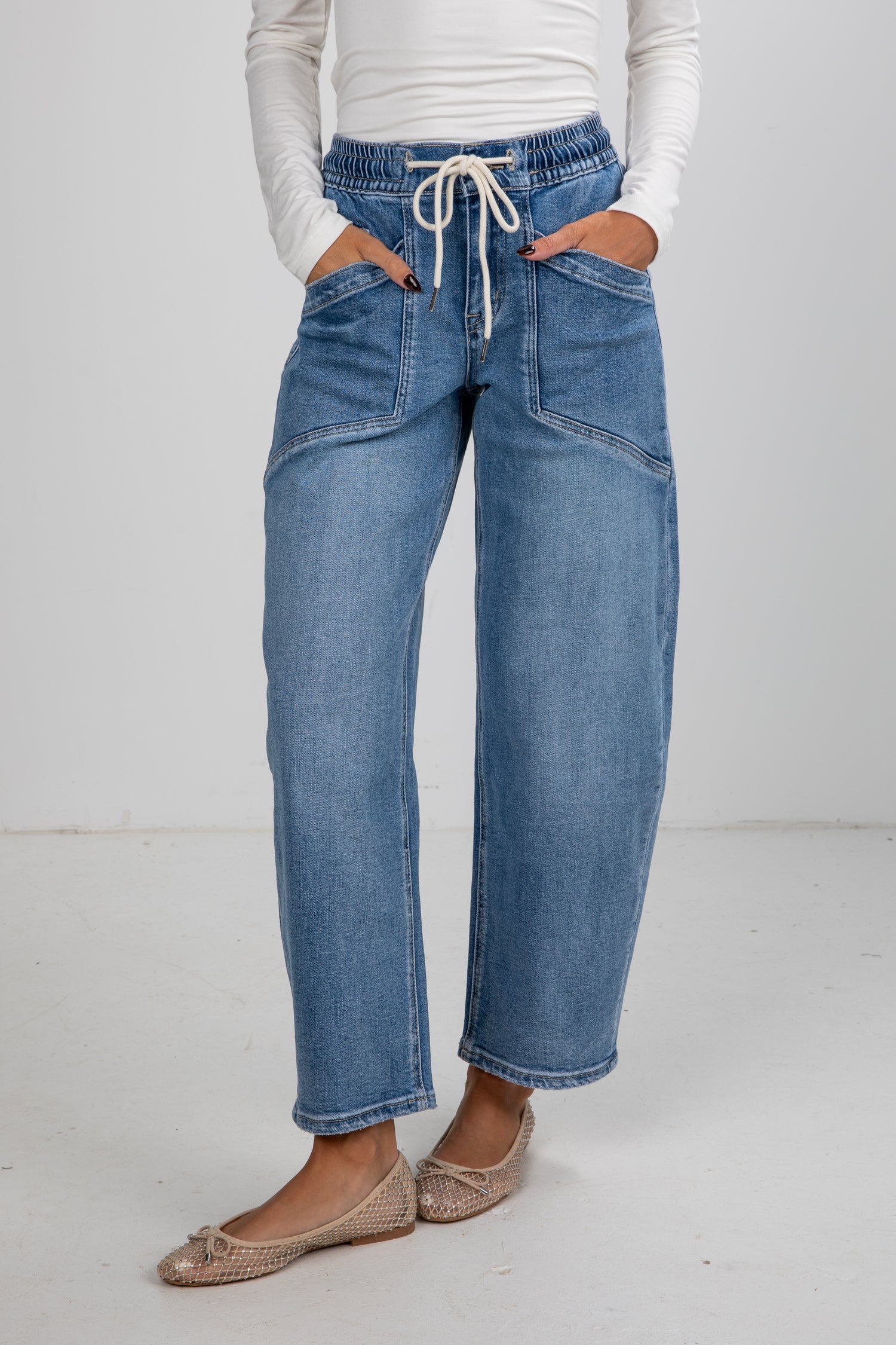 Person wearing blue jeans with a white background