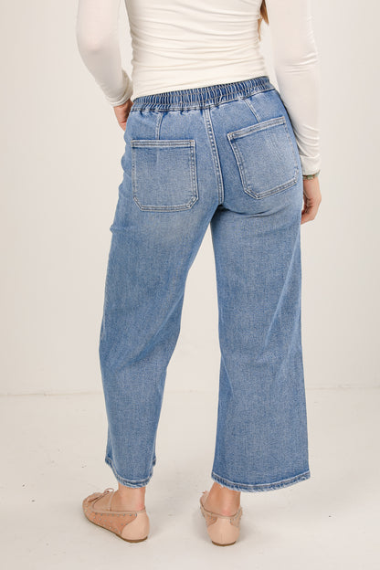 Light blue jeans worn by a person on a white background