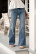 Person wearing blue jeans standing on a porch