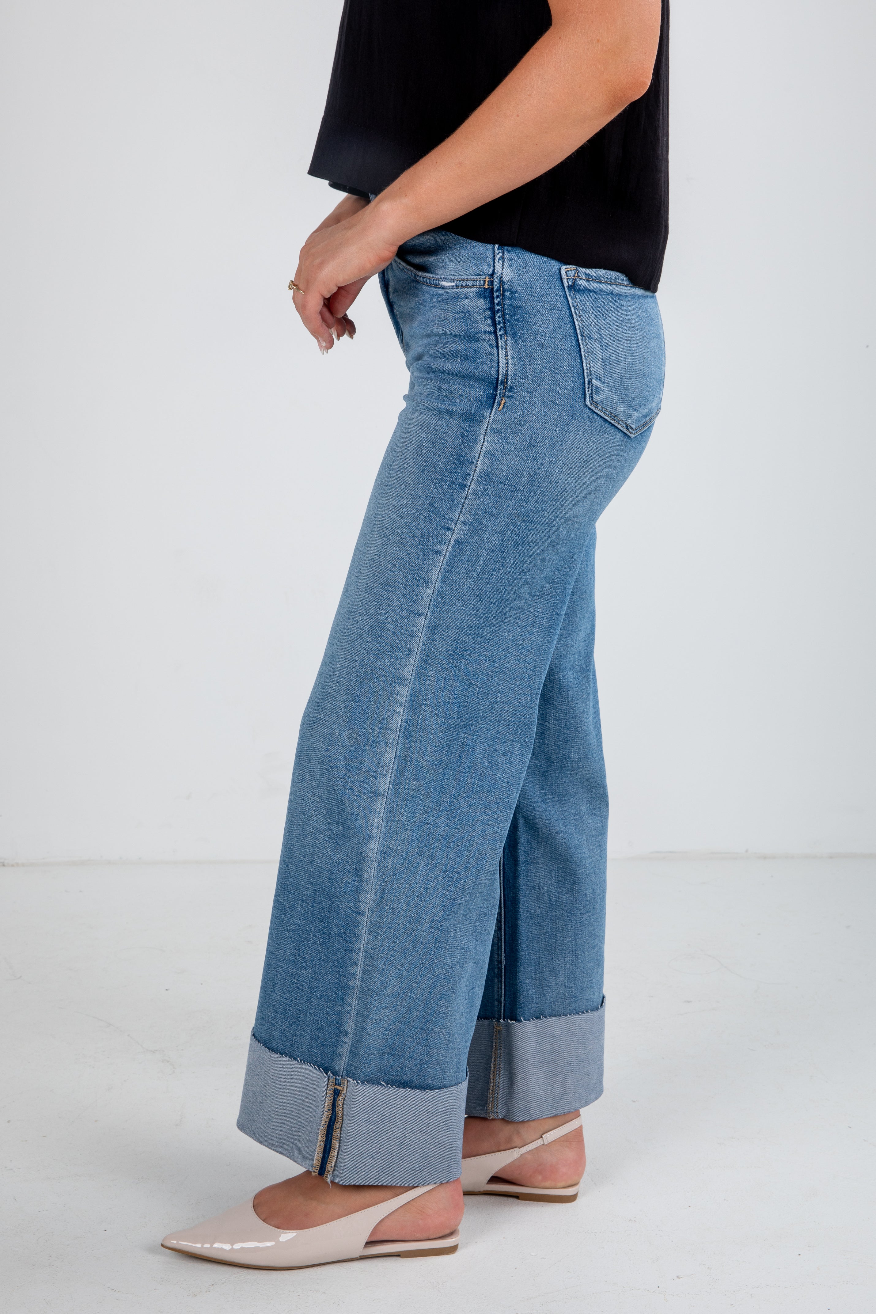 Person wearing blue jeans with a white background
