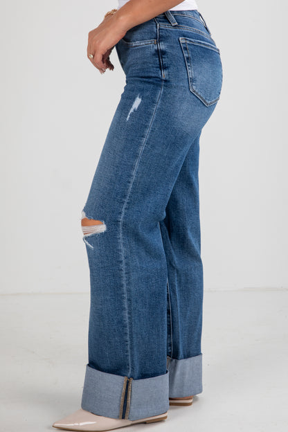 Blue jeans with a distressed design on a white background