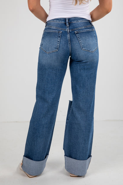 Person wearing blue jeans with a white background
