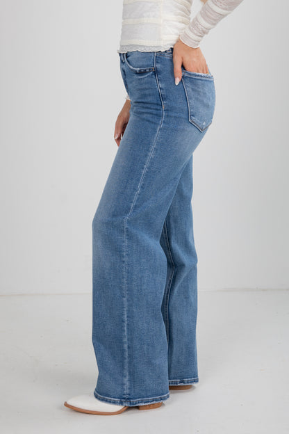 Blue jeans worn by a person on a white background