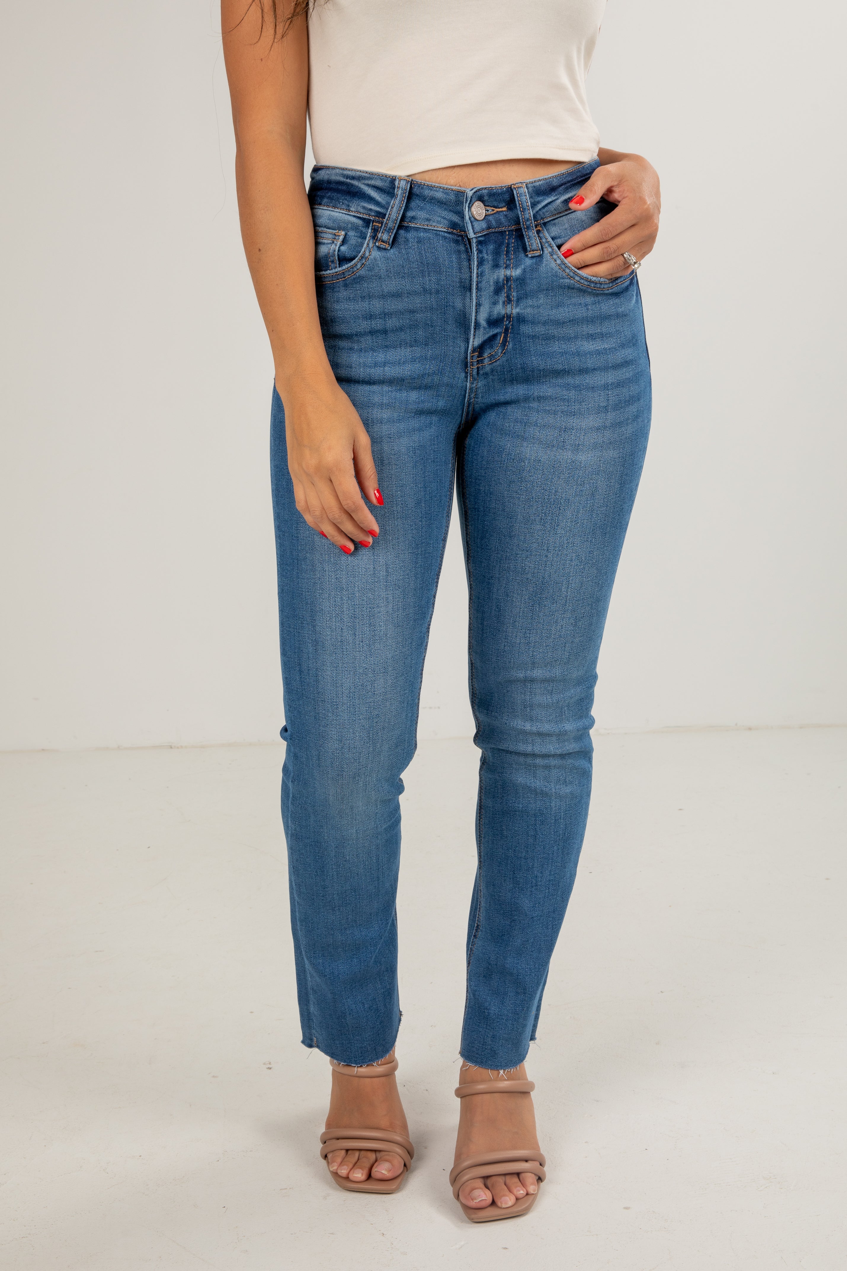 Person wearing blue jeans on a white background