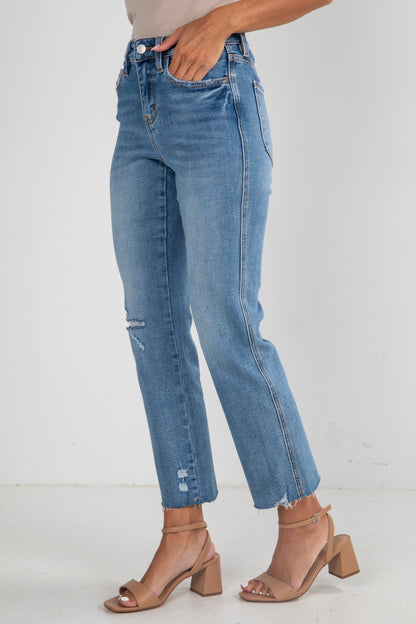 Blue jeans worn by a person on a white background