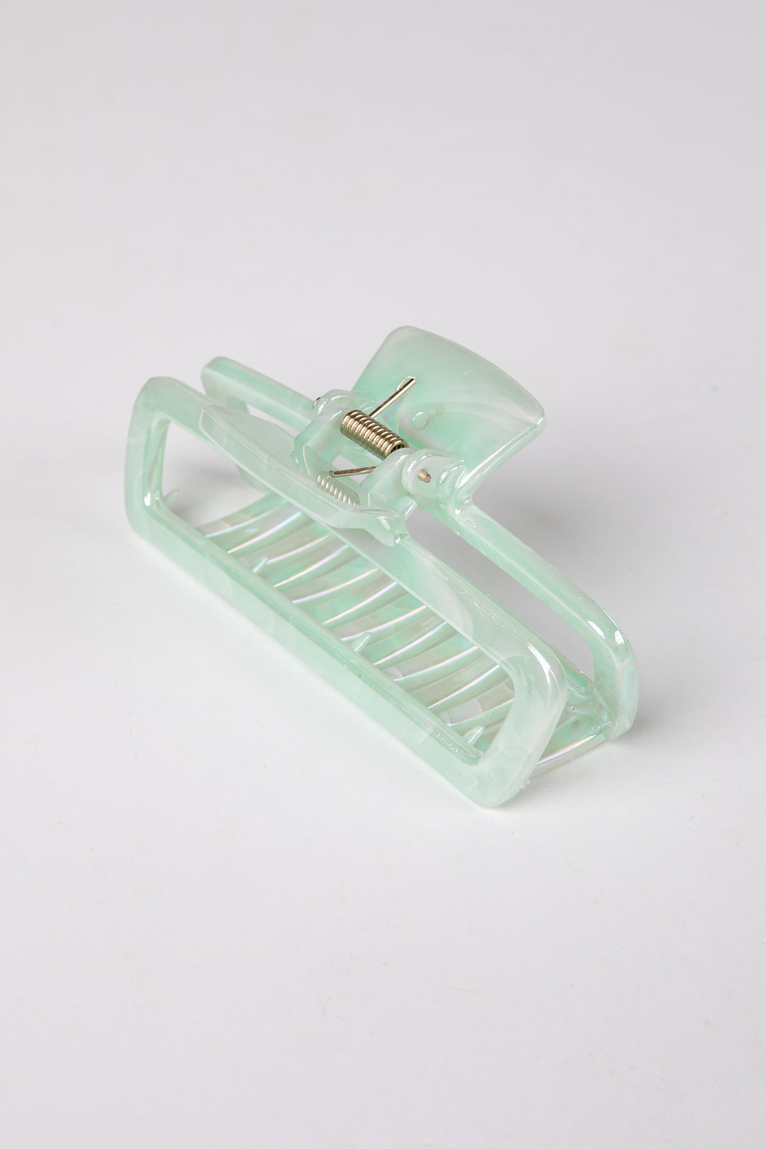 Mint green hair clip on a white background