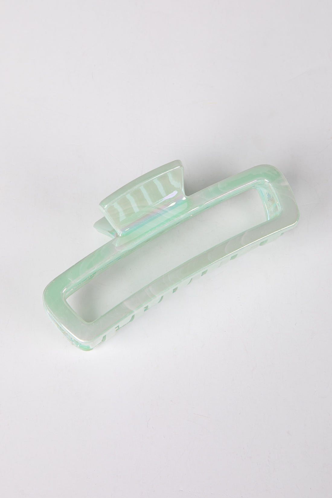 Mint green hair clip on a white background