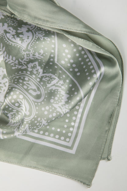 Green bandana with white paisley pattern on a white background