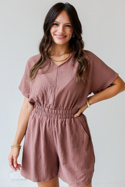 front view of a model wearing a brown Romper for fall