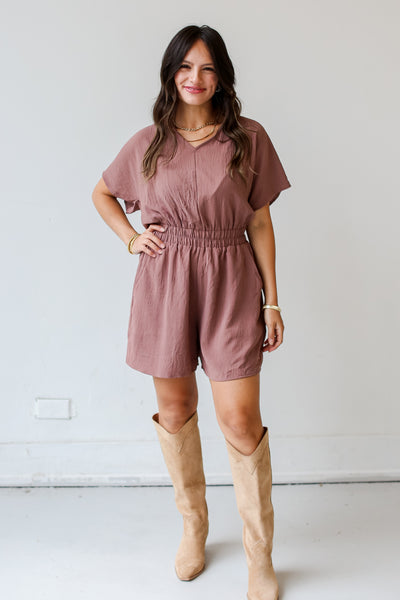 model wearing a brown Romper for fall with boots