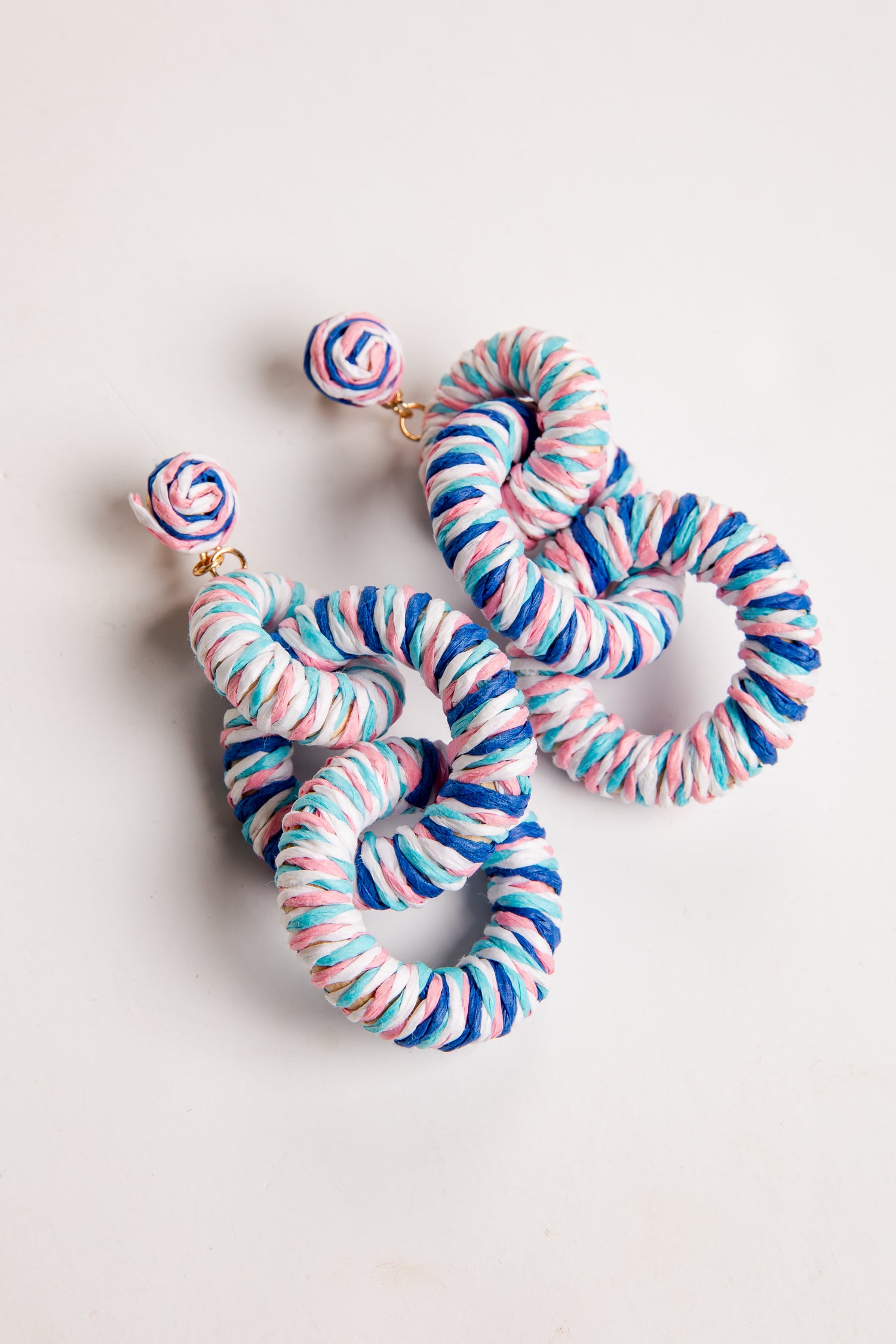 Colorful striped earrings on a light background