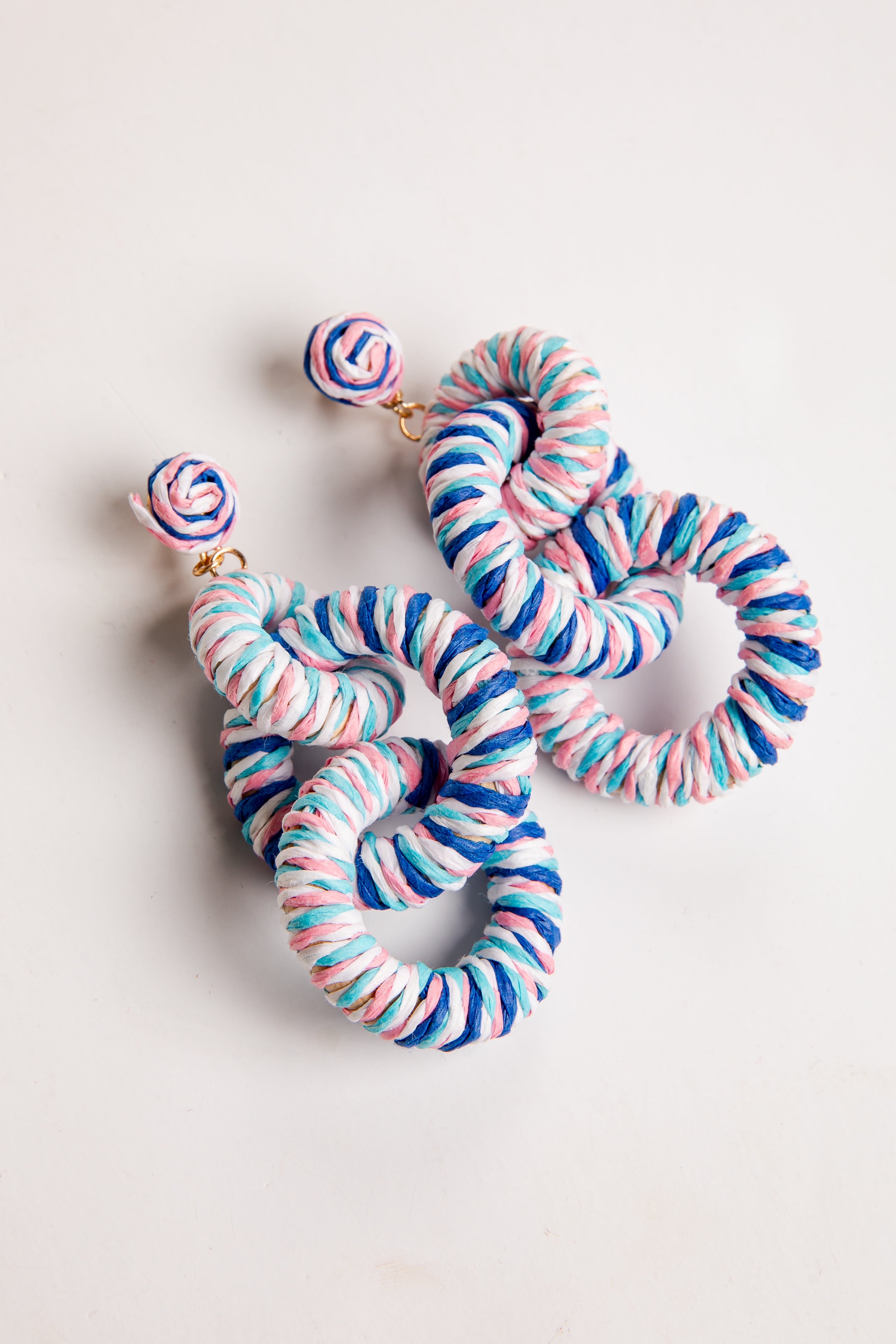 Colorful striped earrings on a light background