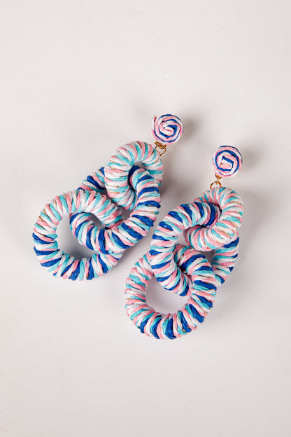 Colorful spiral earrings on a light gray background