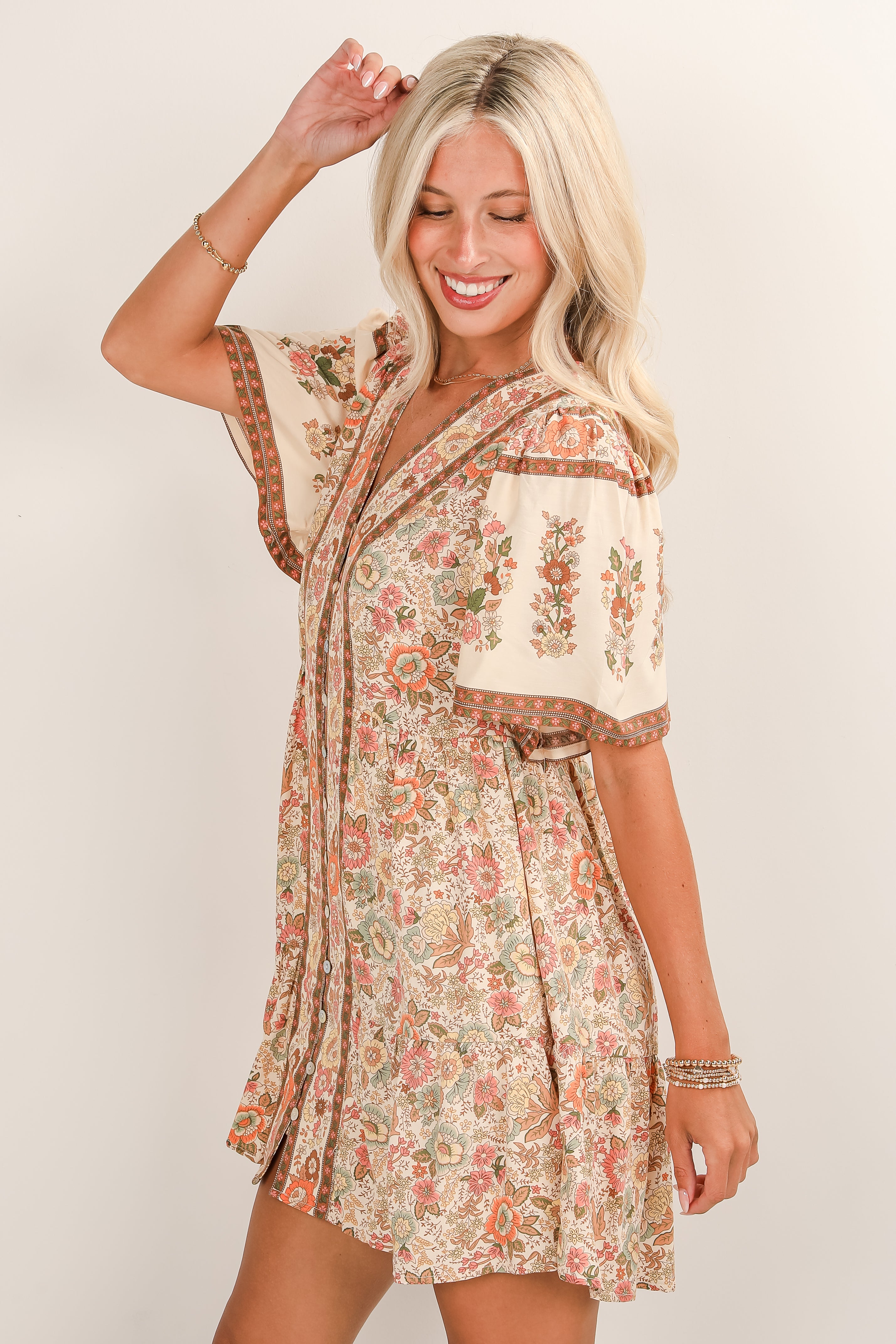 Woman wearing a floral dress with a plain background