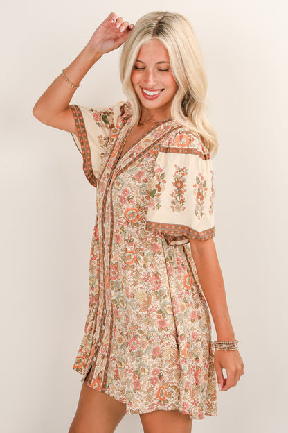 Woman wearing a floral dress with a plain background