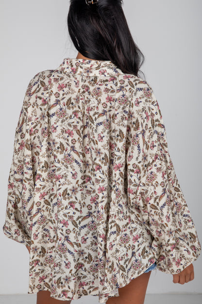 Floral patterned shirt worn by a person on a plain background