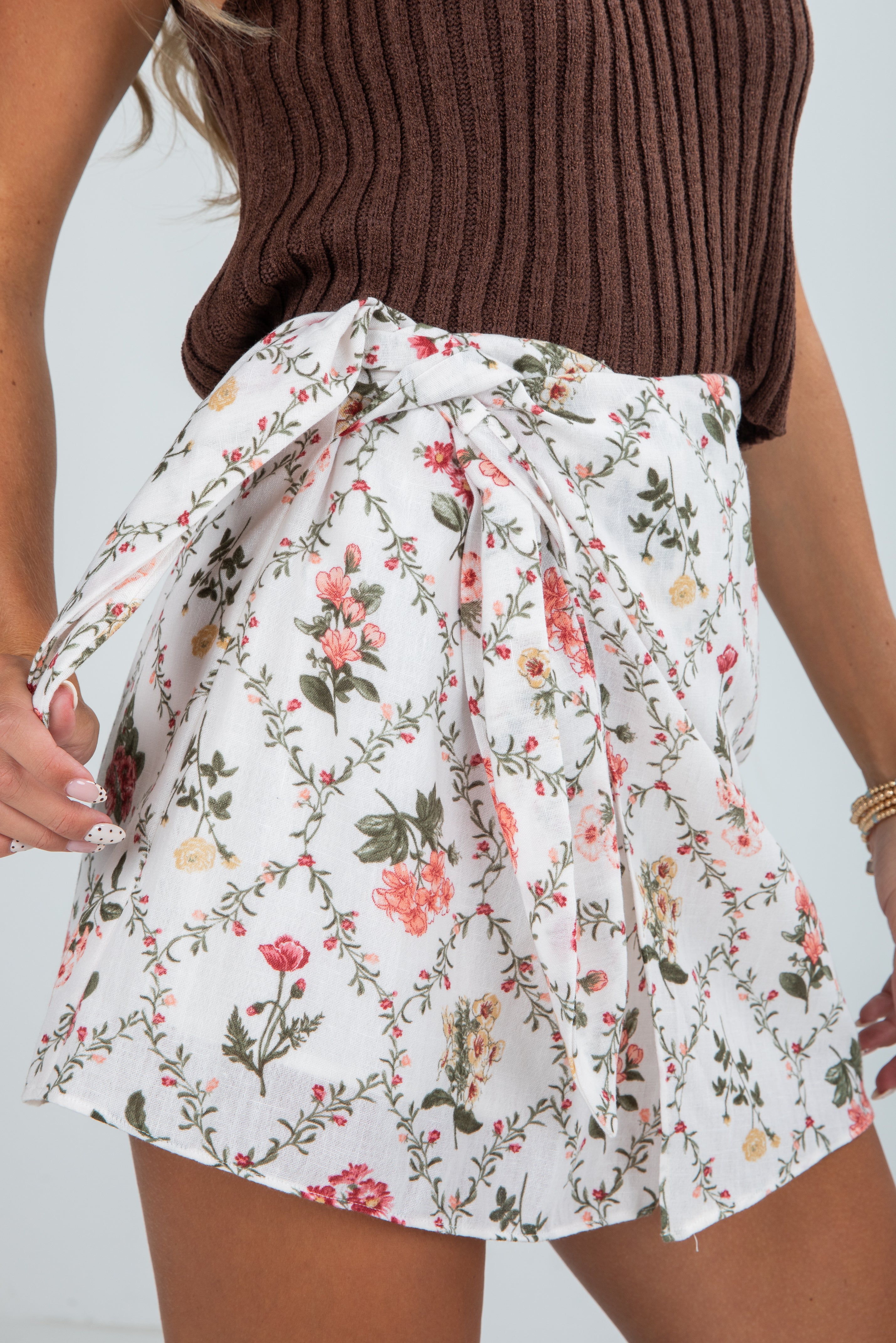 Floral skirt worn by a person with a plain background