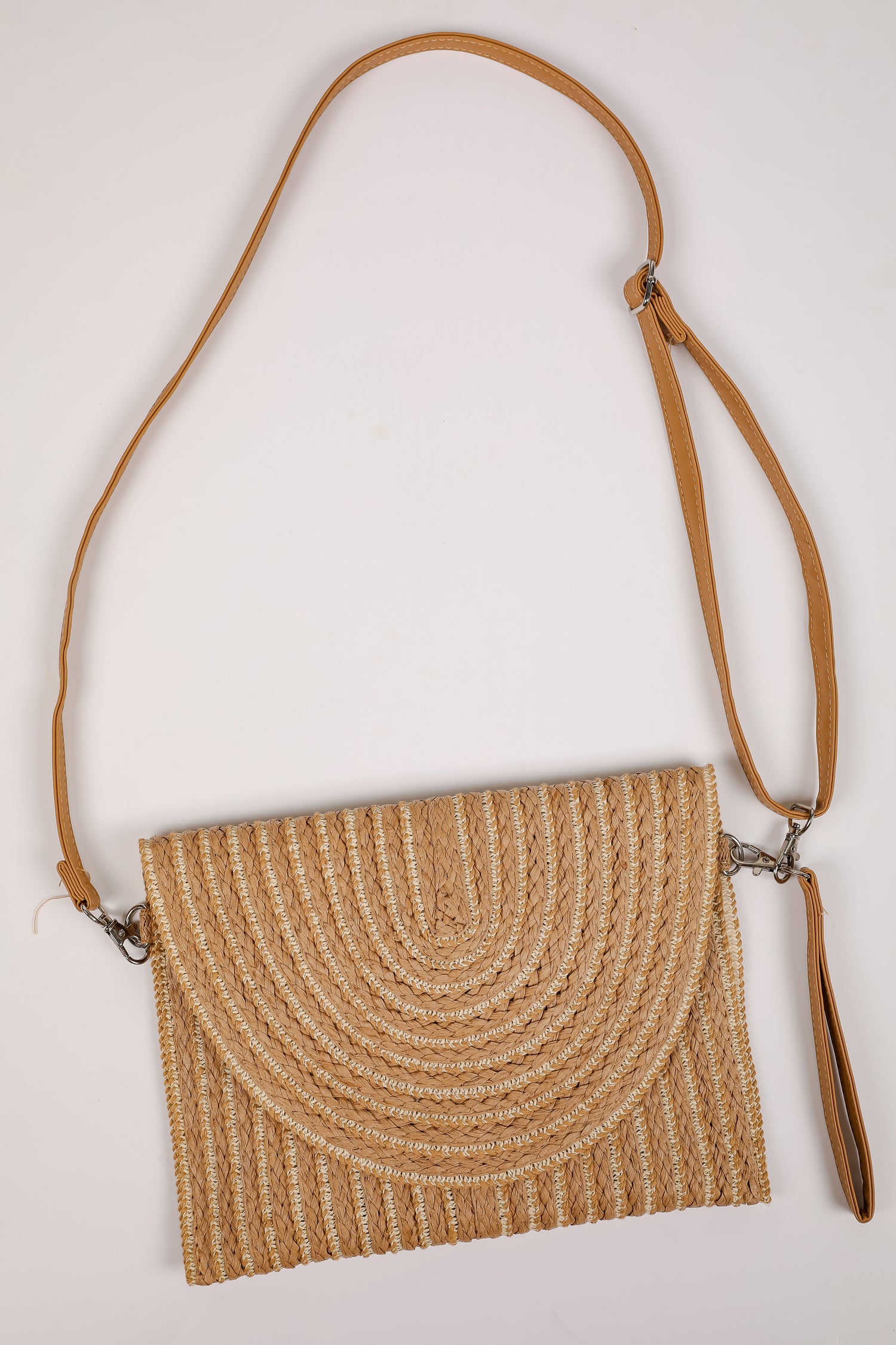 Woven handbag with a brown strap on a light gray background
