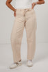 A person wearing beige pinstriped wide-leg pants with a drawstring waist, paired with a white top and white sneakers, standing against a plain light gray studio background.