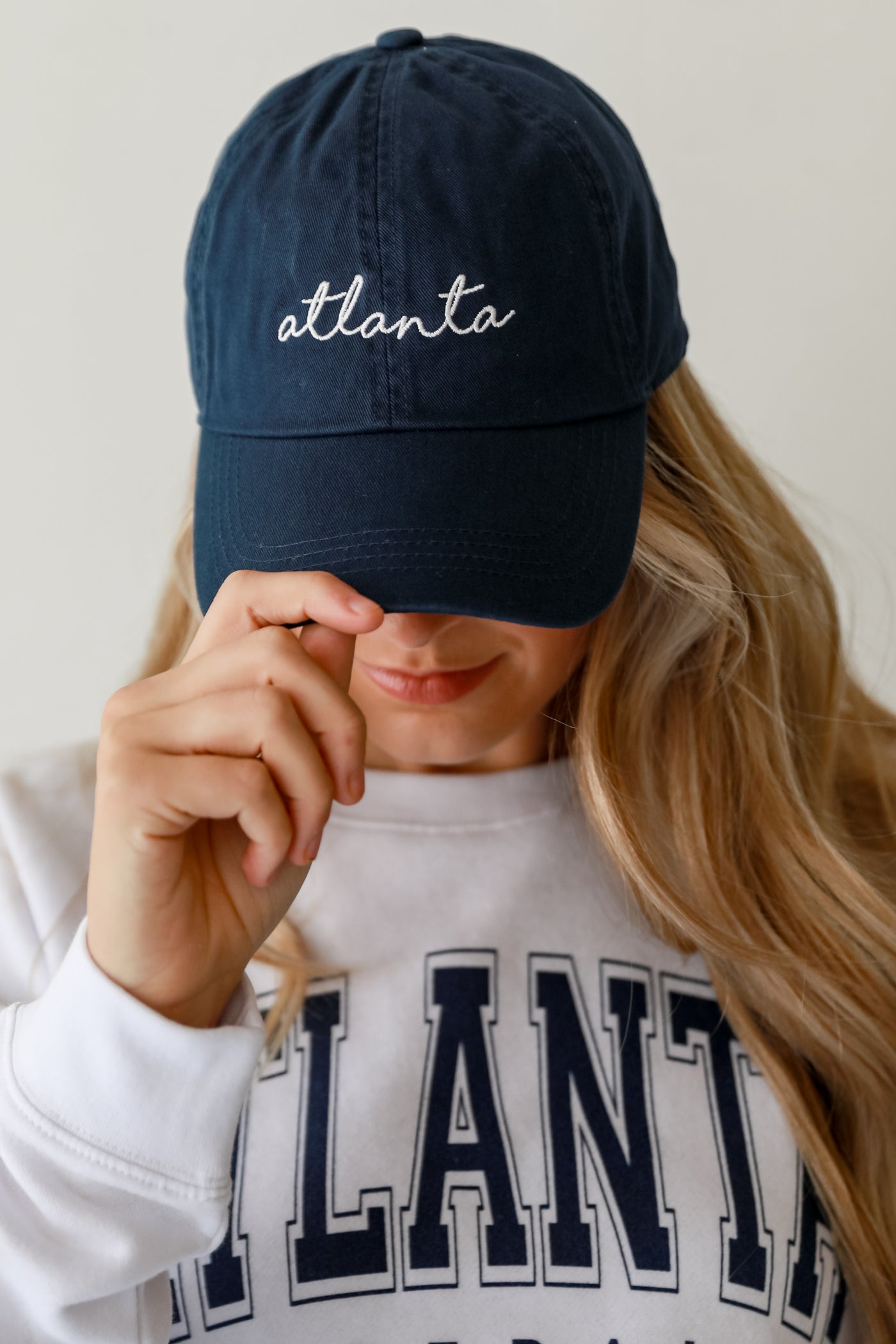 navy Atlanta Script Embroidered Hat on model