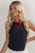 Woman wearing a navy sleeveless top with red text on a plain background