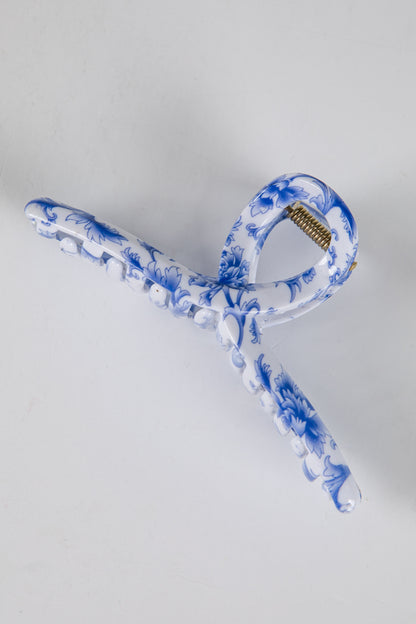 Blue and white ceramic hanger on a light gray background
