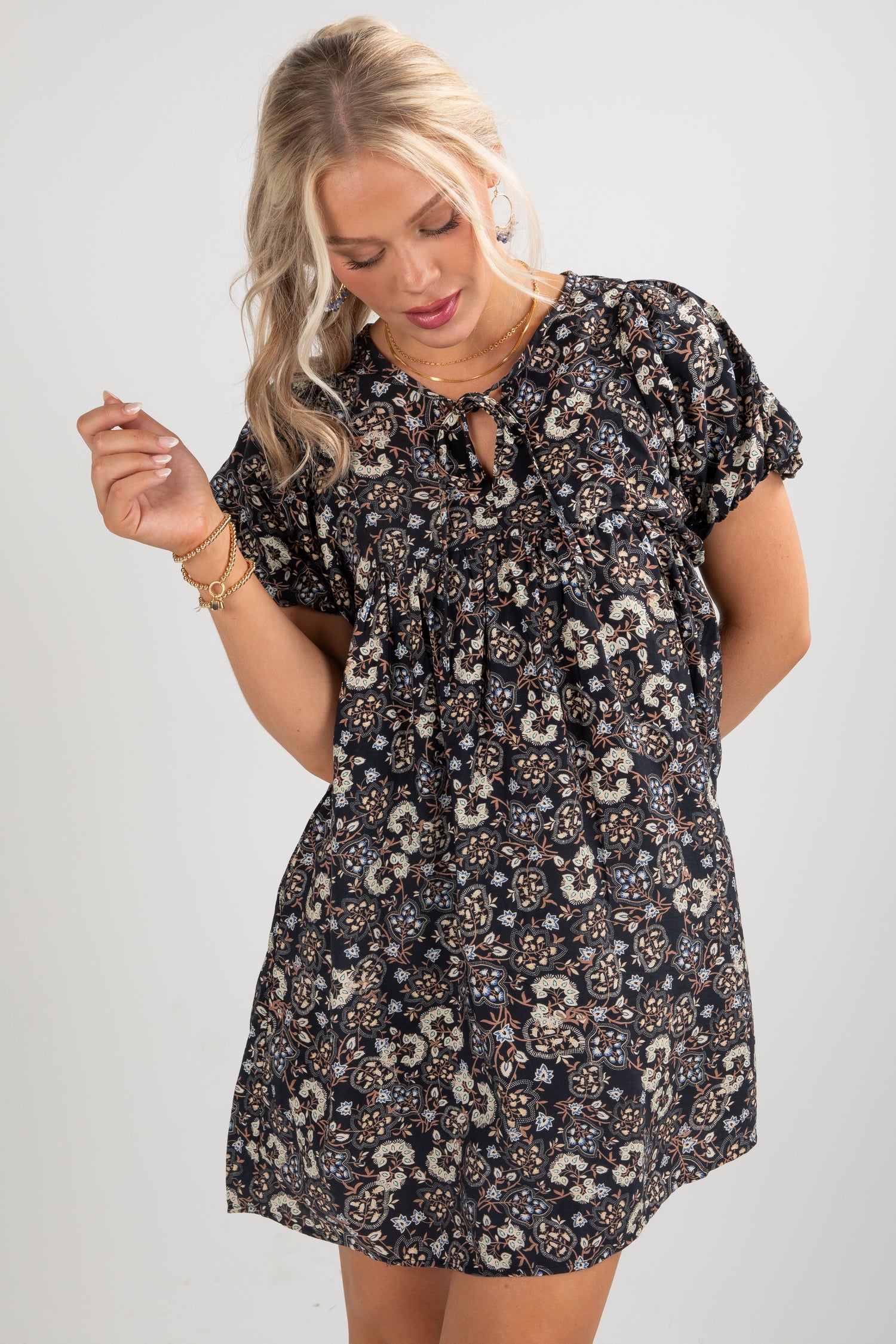 Woman wearing a floral dress on a plain background