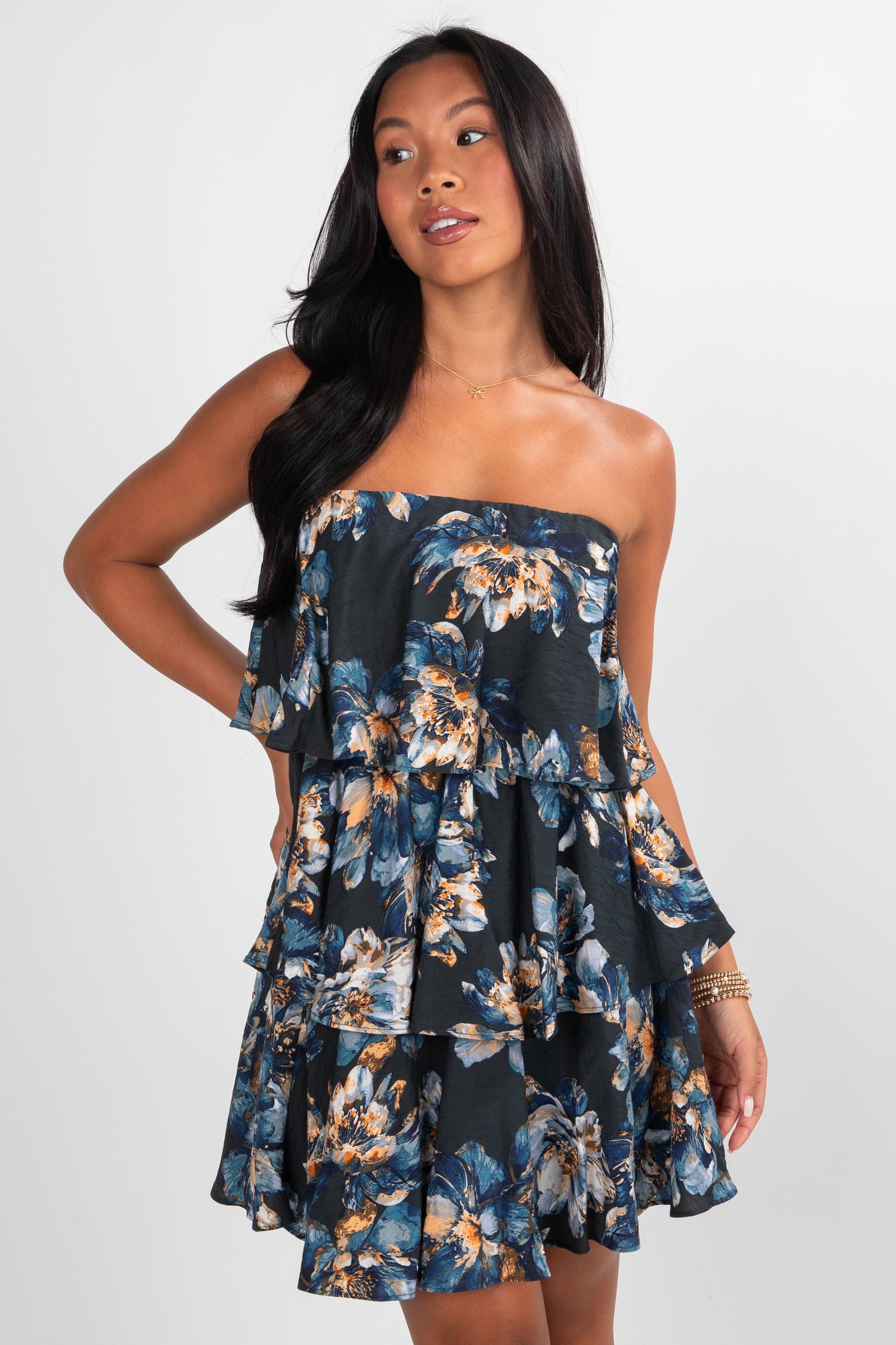 Woman wearing a strapless floral dress on a white background