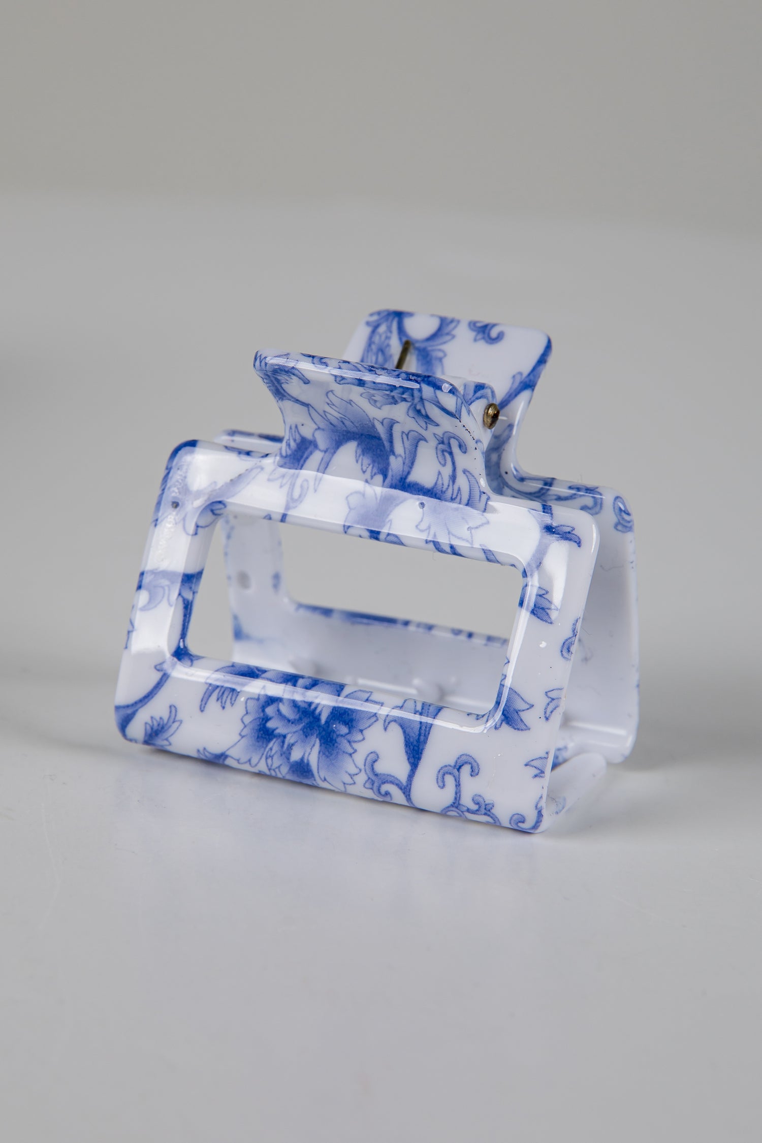 Blue and white patterned handbag on a gray background