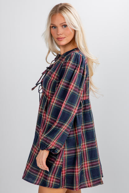 Woman wearing a plaid dress on a plain background