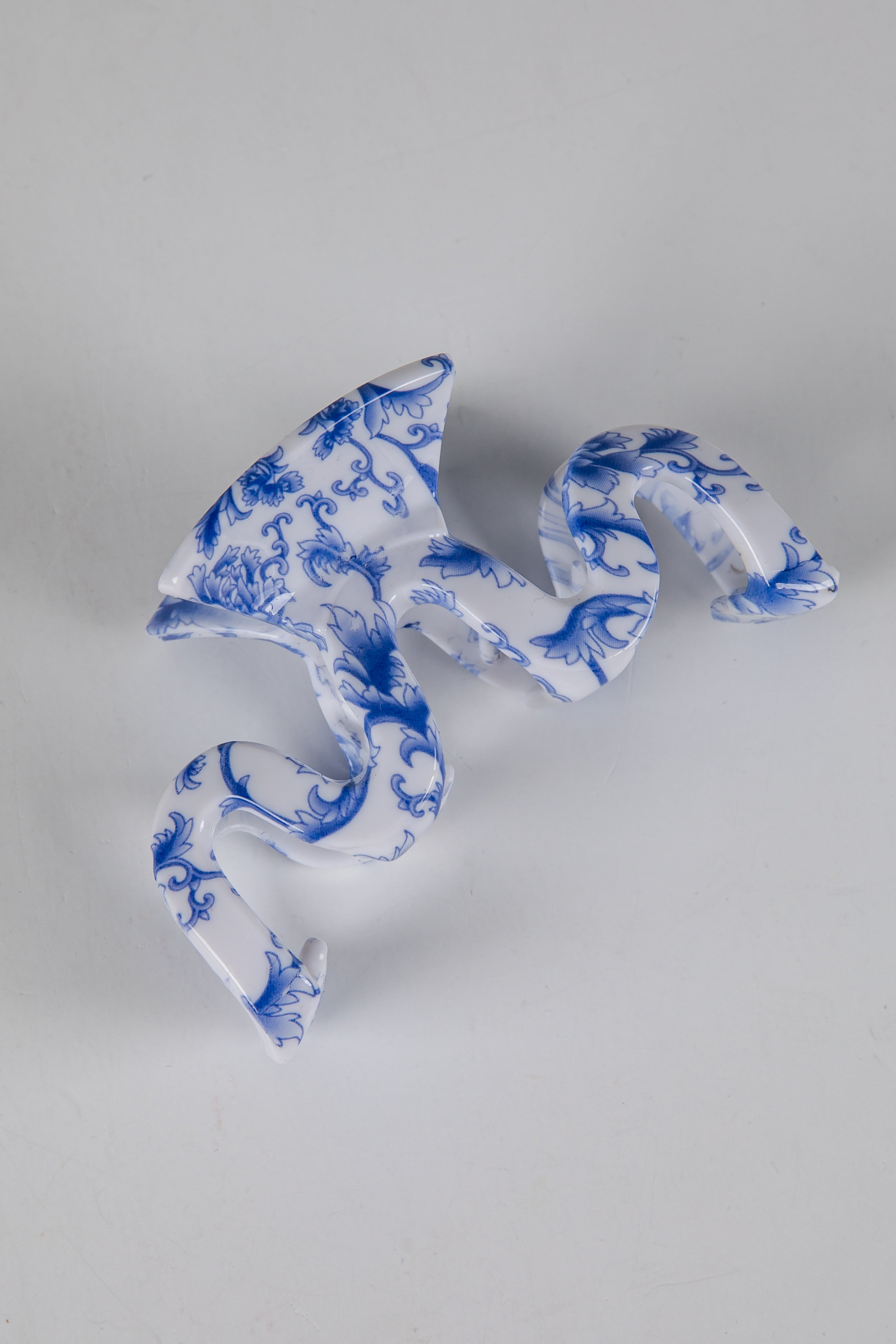 Blue and white patterned fabric on a gray background