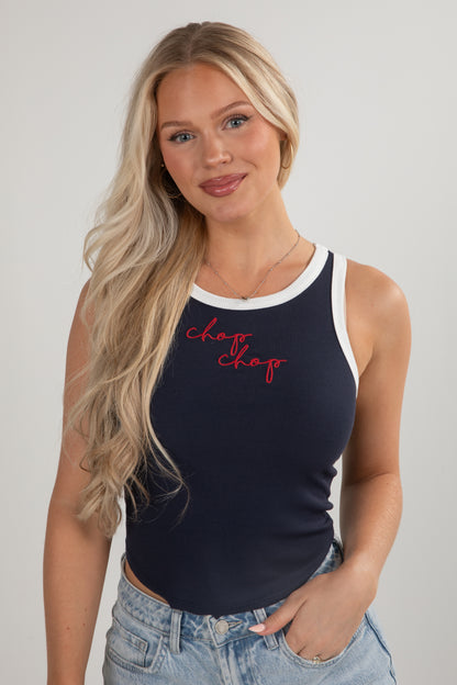 Woman wearing a navy tank top with red text on a plain background
