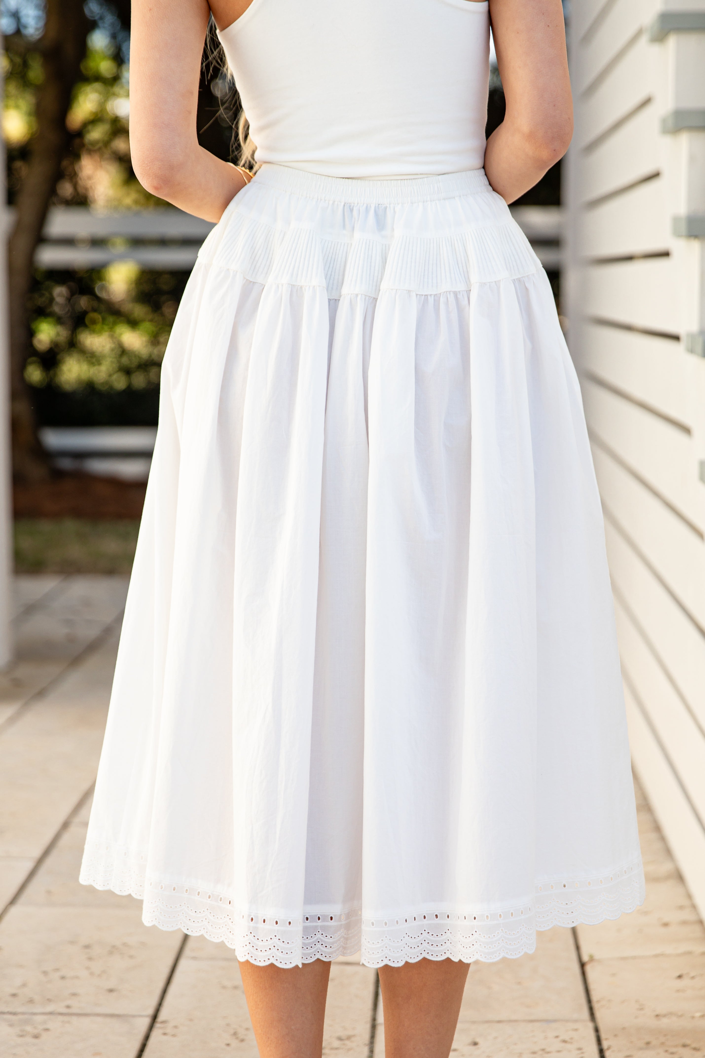 Person wearing a white skirt with a blurred background