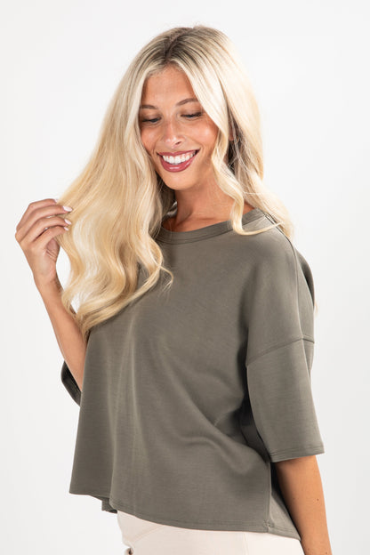 Woman wearing a green oversized shirt on a white background
