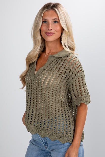Woman wearing a green crochet top against a white background
