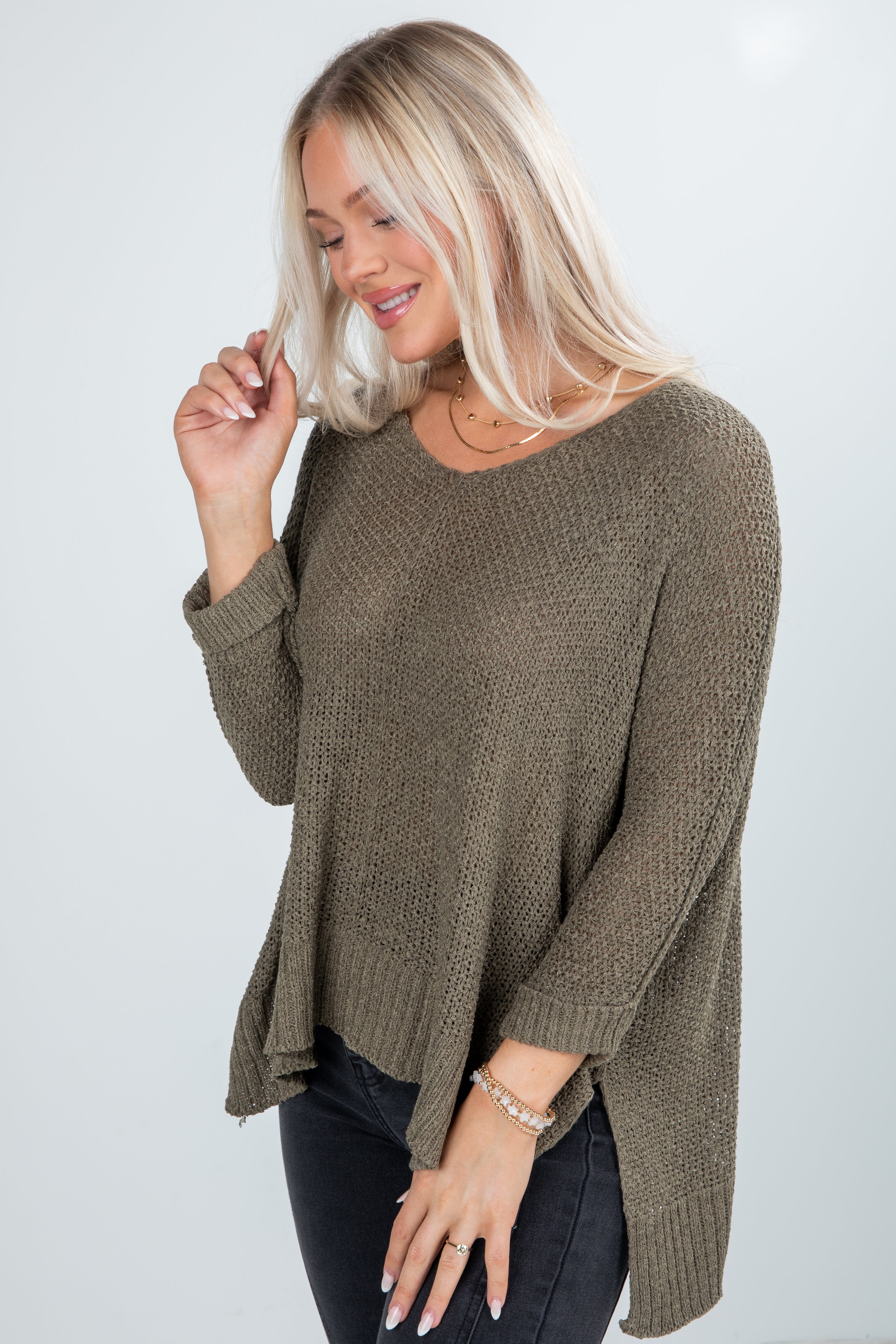 Woman wearing a brown sweater on a white background