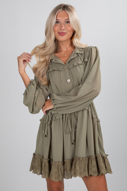 Woman wearing a green dress with ruffled details on a white background