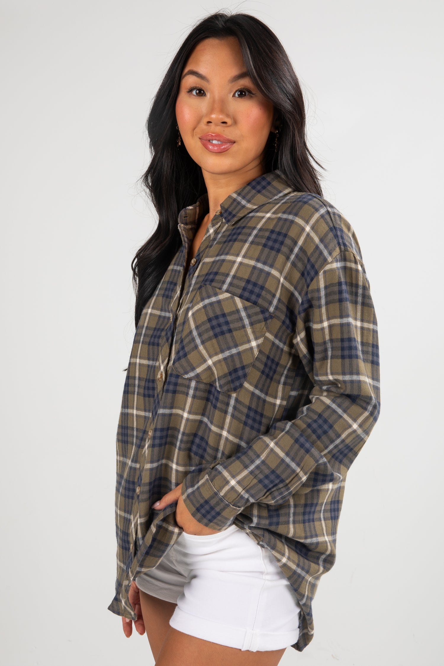 Woman wearing a plaid shirt on a white background